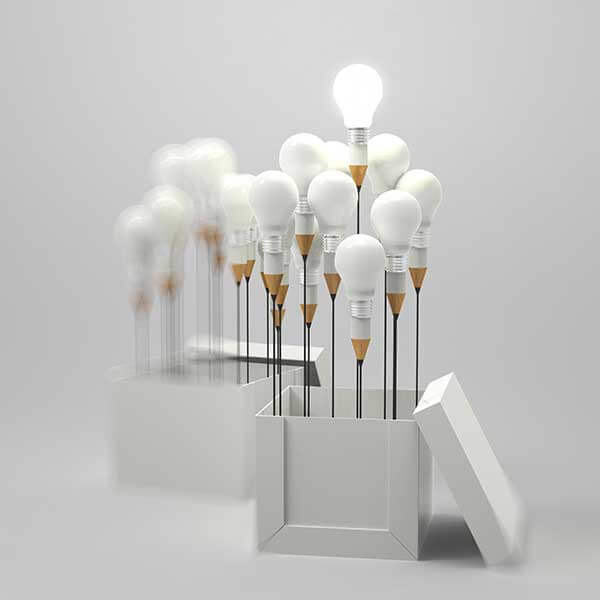 A collection of light bulbs coming out from a white box with the lid standing on its side.