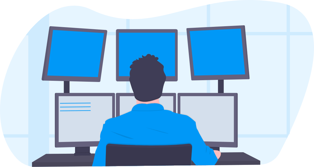 A man with a blue collard shirt and black hair looking into six monitors at his work desk.